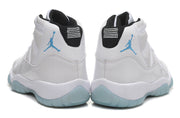 Rear view of the white high-top sneakers showing black heel tabs and light blue logos.