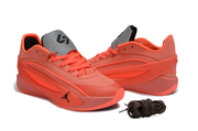 Bright red Jordan basketball sneakers shown in a three-quarter side view with gray tongues.