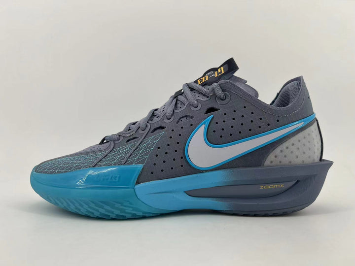 Side view of gray and blue Nike basketball shoes with a contrasting Swoosh and sculpted sole.