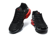 Pair of black and red Nike Air Max Plus sneakers viewed from the front.