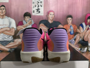 Rear view of the pink and blue basketball sneakers showing matching purple heel panels, black collars, and white midsoles.