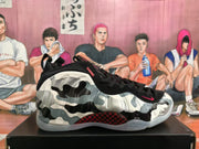 Side view showing the camouflage-style upper, visible Nike swoosh, red-and-black midsole detail, and translucent outsole.