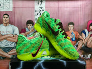 Angled view showing the green textured upper, black laces, side branding, and bright neon outsole.