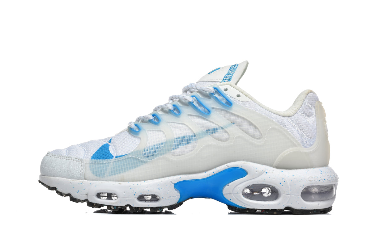 White and blue low-top sneaker with translucent wavy side overlays and visible cushioning windows.