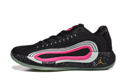 Side profile of one black basketball shoe showing layered white and pink paneling, a speckled black midsole area, and translucent outsole.