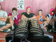 Front view of brown and black Nike sneakers showing the laces, textured toe panels, padded tongues, and black outsole.