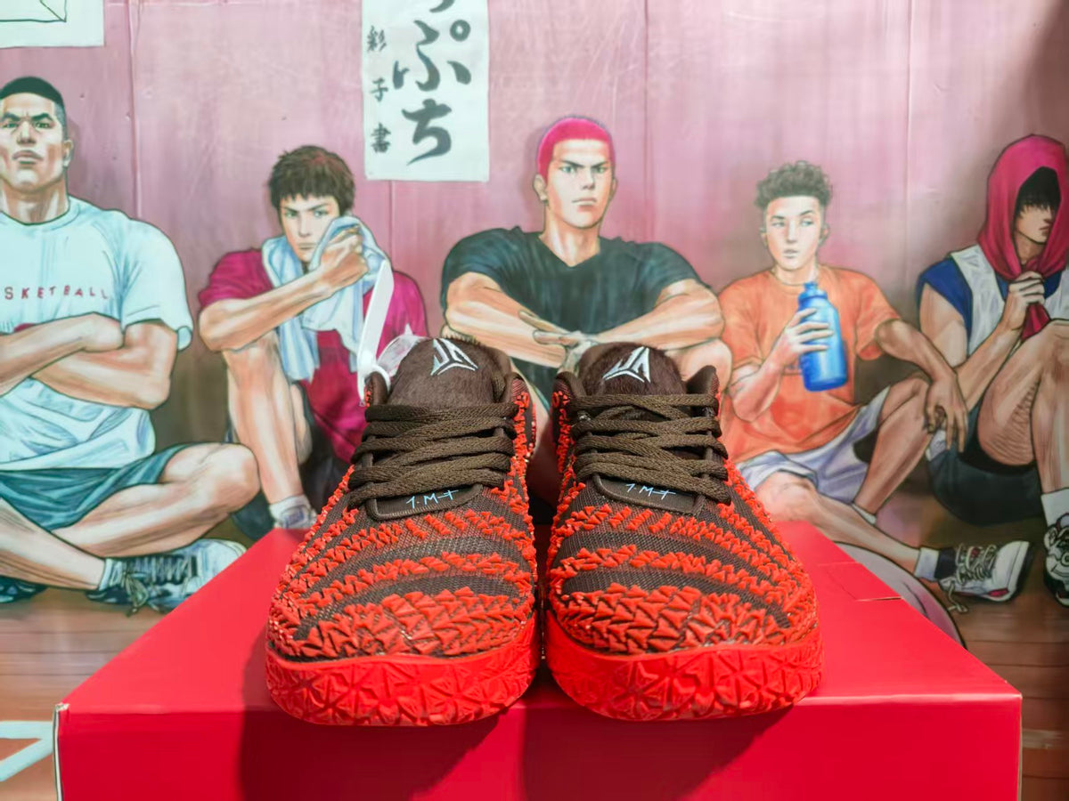 Front view of black and red Nike basketball sneakers displayed on a red box.