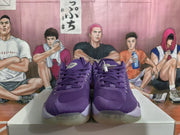 Front view of purple Jordan basketball sneakers showing the lace-up vamp, padded tongues, and translucent toe outsoles.