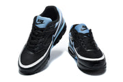 Front view of a pair of black Nike Air Max sneakers with blue tongue panels