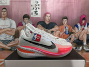 Pair of white Nike basketball sneakers with peach and pink accents, displayed on a shoebox.