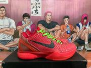 Side view of a red Nike basketball sneaker showing the black Swoosh, textured upper, translucent heel section, and Nike Zoom sidewall branding.