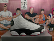 Side profile showing the perforated white upper panel, black overlays, white midsole sections and red outsole edge.