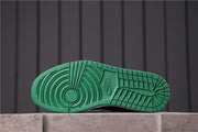 Outsole view showing the green circular traction pattern and textured tread.