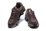 Front view of a pair of dark brown Nike Shox TL sneakers.