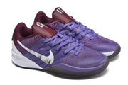Close angled view of purple basketball shoes with burgundy accents and floral-print white Swooshes