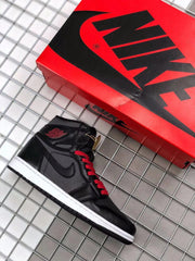 Black and red high-top sneaker shown beside a red shoebox.