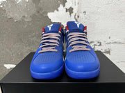 Front view of blue Nike Kobe basketball shoes with patterned laces and white tongue logos.