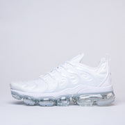 Side profile of a white Nike TN-2 sneaker with sculpted details and a clear segmented sole.