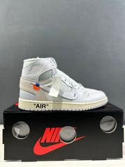 Side profile of a single white high-top sneaker with a beige heel overlay and printed AIR text.
