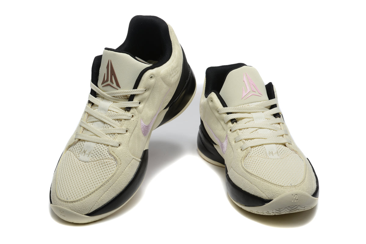 Pair of cream, black and pink Jordan basketball sneakers shown from the front