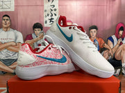 Pair of white Nike shoes with pink patterned side panels, blue Swooshes, and red lining.