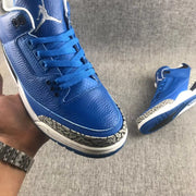 Close-up of the blue toe box, laces, stitching, and elephant-print toe overlay.