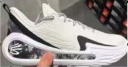 White and black basketball shoe shown from the side, with a sculpted sole and visible cushioning window.