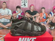 Side view of dark brown Nike Air More Uptempo sneakers on a red shoebox