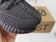 Close-up of the textured black knit-style toe and ribbed outsole edge.