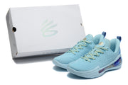 Light blue Curry sneakers displayed beside a white Curry shoebox.