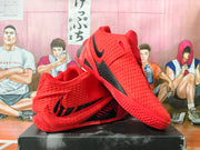 Red and black basketball shoes shown from the side and outsole