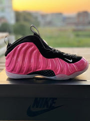 Pink and black high-top Foamposite-style sneaker with a translucent outsole.