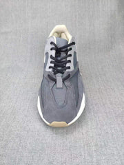 Top-down view showing the grey layered upper, black laces, tongue, and contrasting panels.