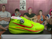 Side view of volt-green Nike basketball shoe with red Swoosh and textured panels.