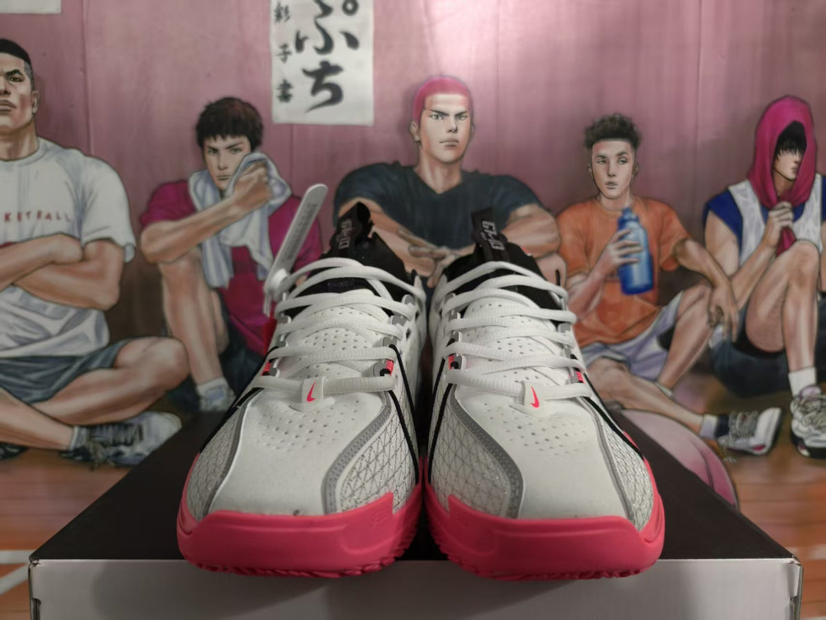 Pair of grey and bright pink Nike LeBron low-top basketball shoes viewed from the front.