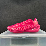 Side profile of a bright pink Nike basketball sneaker highlighting the sculpted side detailing and white Swoosh.