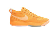 Orange low-top Nike Book 1 shoe with a light-colored Swoosh
