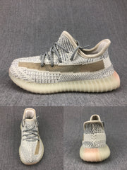 Side, top, and rear views of a cream-white and gray knitted kids sneaker with a contrasting side stripe.