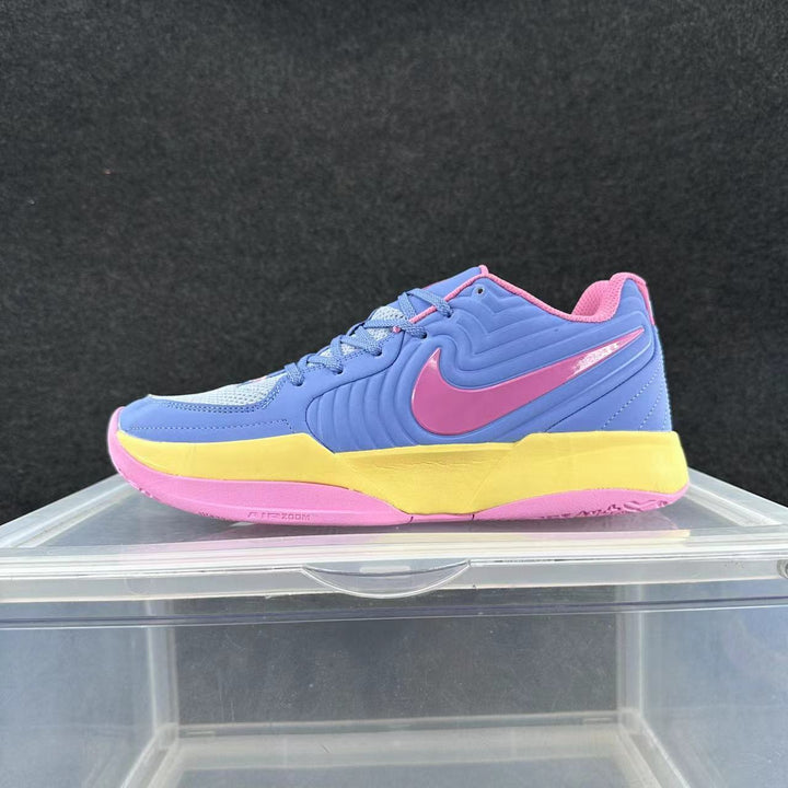 Side view of a blue Nike basketball sneaker with a pink swoosh and outsole and a yellow midsole section.