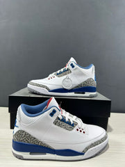 Close side view of the white and blue Air Jordan 3 pair, highlighting the perforated upper and elephant-print overlays.