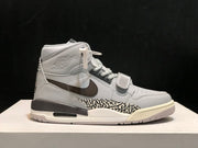 Opposite side profile of the grey high-top sneaker with Jordan wing graphic and layered sole.