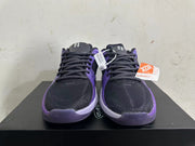 Front view of black and purple lace-up basketball shoes with contrasting purple trim.