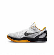 White and black Kobe 6 sneaker with gold trim and a gold-colored outsole section.
