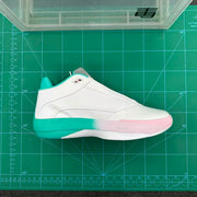Side profile of a white basketball shoe with turquoise heel and pale pink forefoot accents.