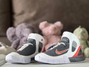 Front three-quarter view of the pair, showing the high-top shape, logo details, and white outsoles.