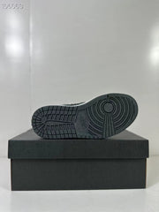 View of the black rubber outsole showing its circular and segmented tread pattern.