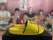 Side view of the yellow slide sandal with black trim and a visible Nike Swoosh.