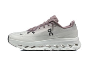 Side profile of a white and mauve On Cloudmonster 3 shoe.