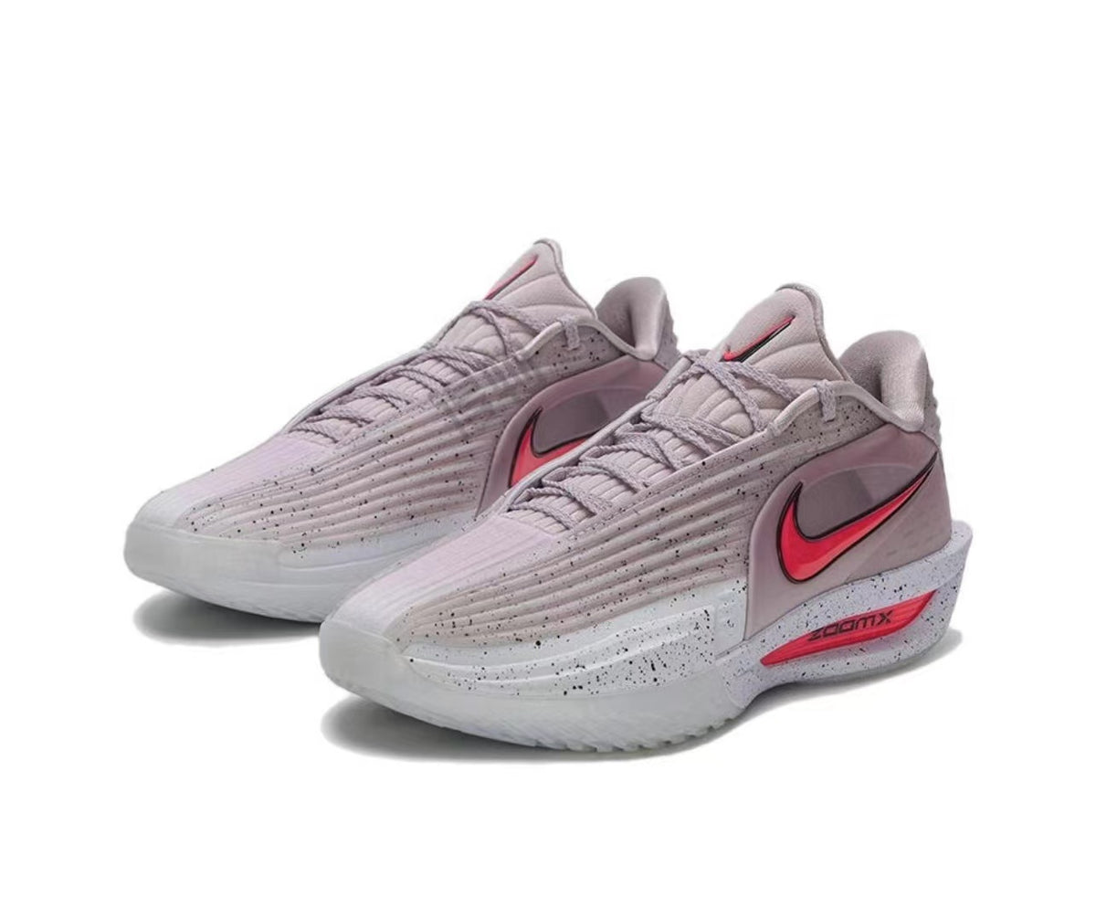 Pair of pink and gray Nike running shoes with red Swoosh details, textured uppers, and speckled midsoles.