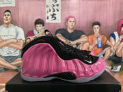 Side view of a pink and black high-top basketball shoe showing its sculpted pink shell.
